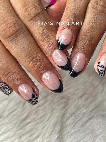A reminder to book your next session. This design features a modern black French tip with a cool crocodile print accent nail.