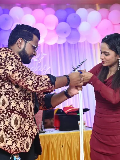 A guest helps me with a classic magic wand illusion. This is a simple yet baffling trick that is great for getting people involved and laughing at parties and events.