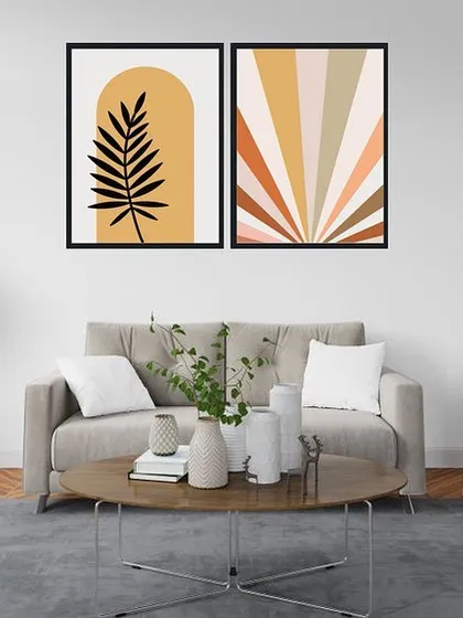 This set of two framed prints features a modern abstract design inspired by Henri Matisse. The combination of a bold leaf silhouette and a colorful sun-ray pattern creates a vibrant and artistic pairing.