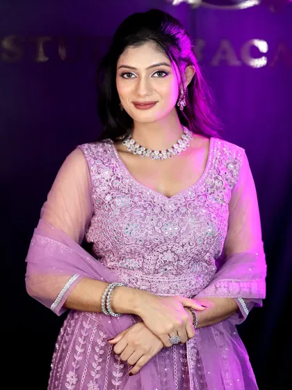 A confident and elegant pose. The makeup is designed to look stunning under the evening lights of a reception party.