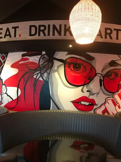 Art sets the vibe. For this restobar, we designed and painted a custom pop-art mural that defines the space's cool, modern aesthetic. This kind of art turns a simple wall into a feature that customers will want to share online.