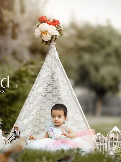 A world of wonder in her eyes. This outdoor first birthday session with a lace teepee and colorful dress is the definition of childhood magic.
