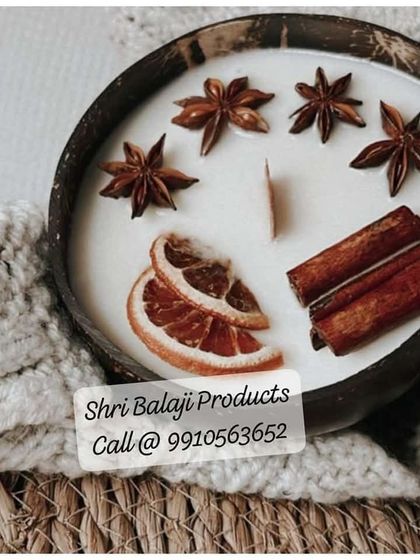 Another beautiful example of a decorated candle, this time in a coconut shell with star anise, cinnamon sticks, and dried orange slices for a warm, spicy look.