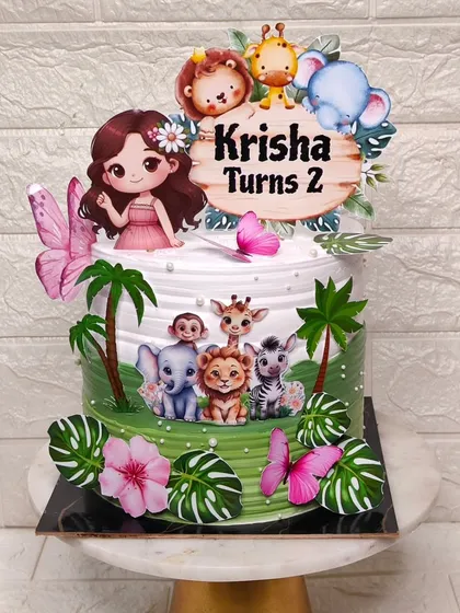 A different style of jungle theme cake, this one with a girl character and lots of tropical leaves and butterflies for a 2nd birthday.