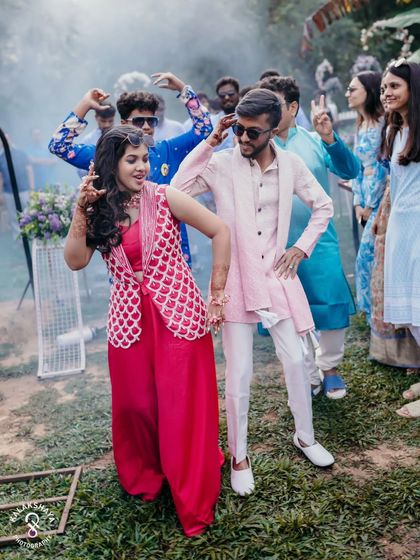 The couple and their friends dancing with abandon during a fun outdoor pre-wedding event.