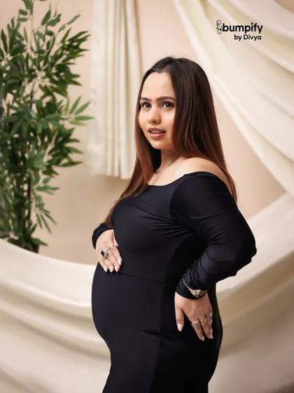 A close-up shot focusing on the mom-to-be's serene expression and her hands cradling the bump. A beautiful, simple celebration of motherhood.