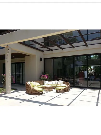 The indoor and outdoor spaces merge seamlessly in this Khandala home, thanks to large sliding glass doors. The patio features a unique circular sofa, ideal for social gatherings.