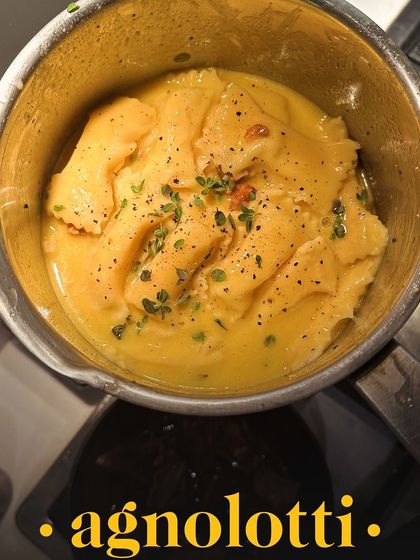 A close-up of the agnolotti in the pan, a staple at my private dining events, showcasing its rich, buttery sauce.
