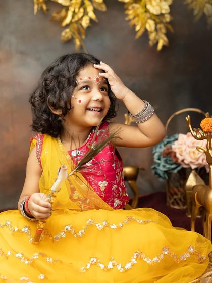 A joyful smile from a little girl dressed as Radha, captured during our Janmashtami special photoshoot.