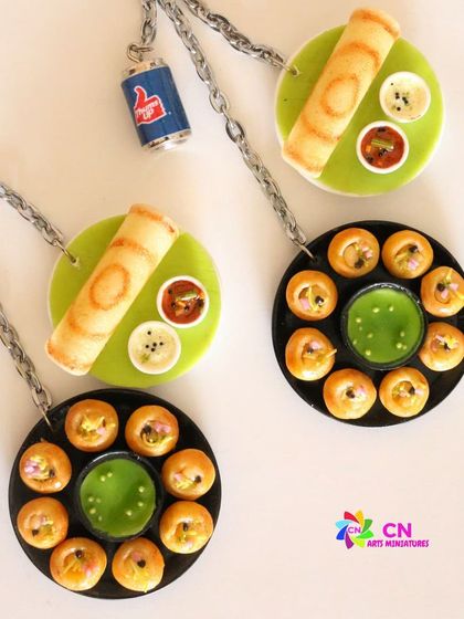 An assorted keychain with pani puri and dosa, a classic combination.