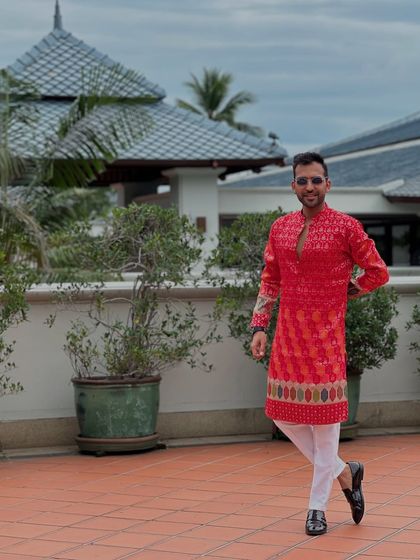 Rocking a bright red kurta for a Baraat in Thailand. My wardrobe for destination weddings is always vibrant and perfectly suited for the celebratory, picturesque environment.
