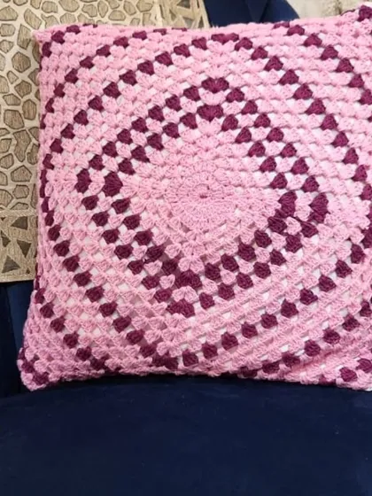 I love making granny square patterns. This cushion cover is made with soft pink and purple cotton yarn, and the design is a classic. It will make any chair look so cozy.