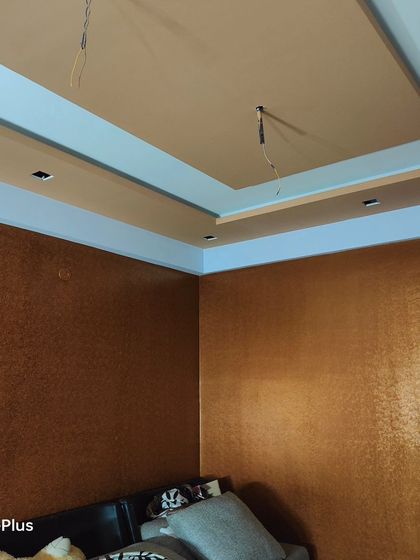 A corner view of a room with a rich, bronze-colored textured paint. This type of finish is excellent for creating a warm and inviting atmosphere, especially in a living room or den.