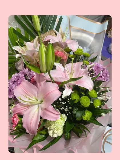 A close-up of our mixed floral bouquet, showing the fresh textures and colors of the lilies and chrysanthemums. We personally handpick every flower for quality.