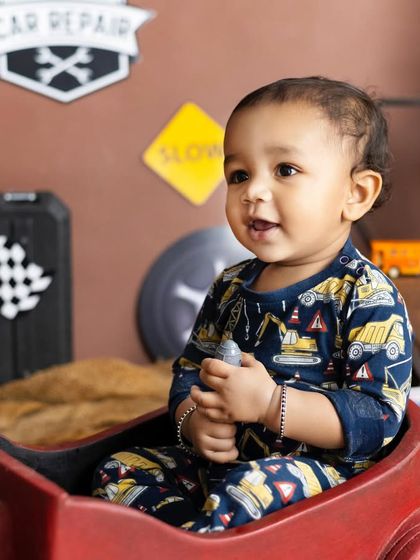 For the little one who loves cars and trucks. Our garage-themed shoot is full of fun props like signs, tools, and a toy car.