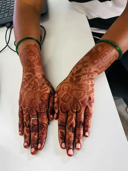 A stain check on a detailed design. You can see the rich, reddish-brown color that has developed, highlighting all the intricate patterns beautifully.