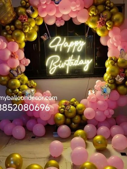 A repeat of the glamorous pink and gold birthday decoration, showing the full effect with balloons covering the floor. This setup is perfect for a princess or queen-themed party.