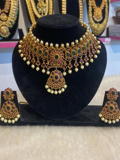 A beautiful temple choker with ruby and green Kemp stones and pearl drops. This piece can be rented on its own or as part of a larger set.