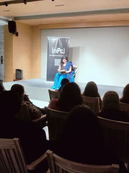 A performer on our stage during a Non-Aligned Poets Collective event. The minimal setup puts the focus squarely on the power of the spoken word.