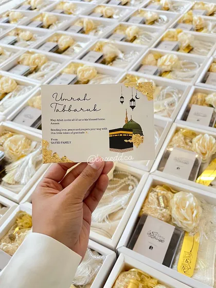 A close-up of the custom "Umrah Tabarruk" card I designed for a client's return gifts, adding a personal touch to each box.