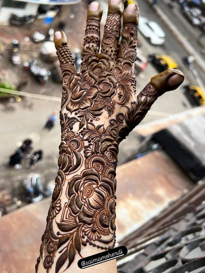A full arm design showcasing intricate floral work. This is perfect for someone who wants a truly statement making mehendi look.