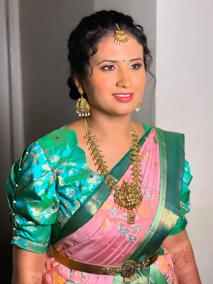 A close-up portrait of Swathi, highlighting her flawless skin and bright smile.