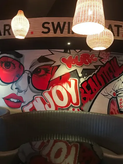The complete pop-art and graffiti mural, blending different styles to create a visually exciting and cohesive piece that enhances the entire room.