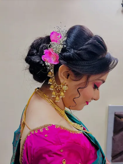The other side of the floral bun, showing the placement of the flowers and the 'kaan vel' earring chain.