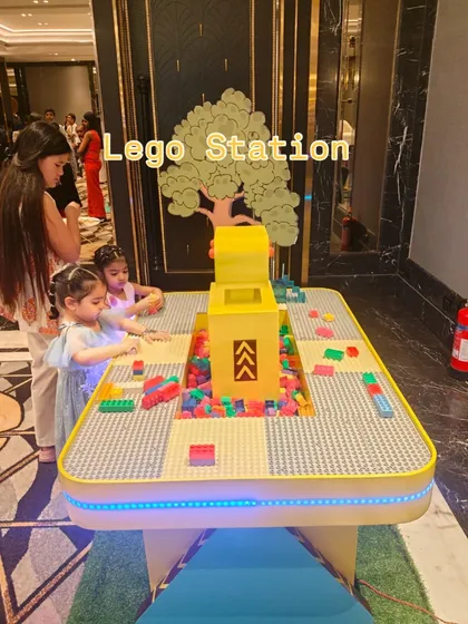Our LED-lit Lego station is a popular choice for engaging kids' creativity. The table is filled with thousands of bricks and provides a dedicated space for children to build and play together at birthday parties or corporate family days.