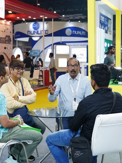 A lively discussion takes place at a networking table, highlighting the collaborative spirit of the event.