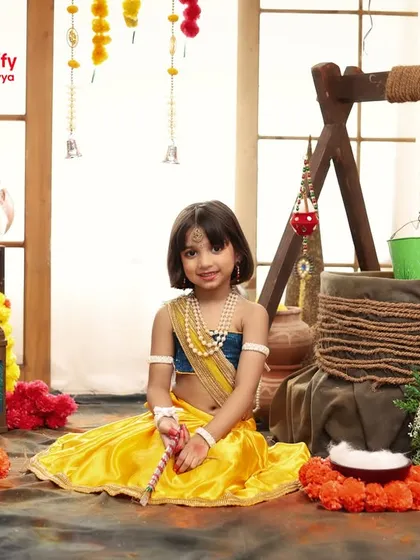 Our little Radha sits peacefully in the Vrindavan inspired studio setup, a perfect portrait for Janmashtami.