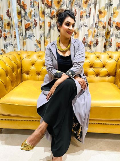 A candid shot from the shoot with the fashion stylist, showing her relaxed and confident in her glamorous makeup.