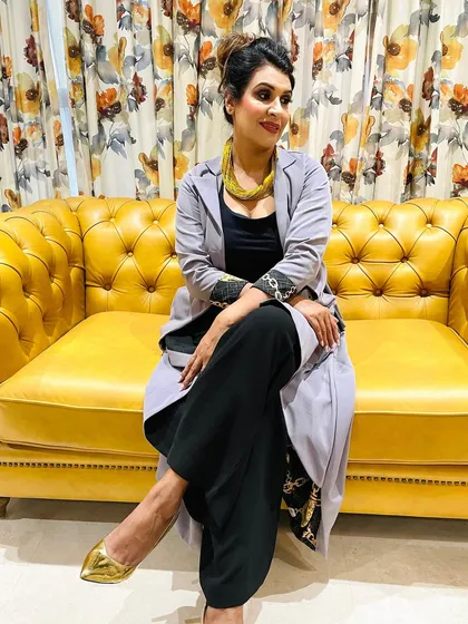 A candid shot from the shoot with the fashion stylist, showing her relaxed and confident in her glamorous makeup.