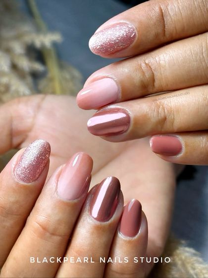 This is one of my most requested designs, recreated over 50 times. It features a mix of nude shades, a stunning chrome accent, and a sparkling glitter nail, making it a versatile and beloved classic.