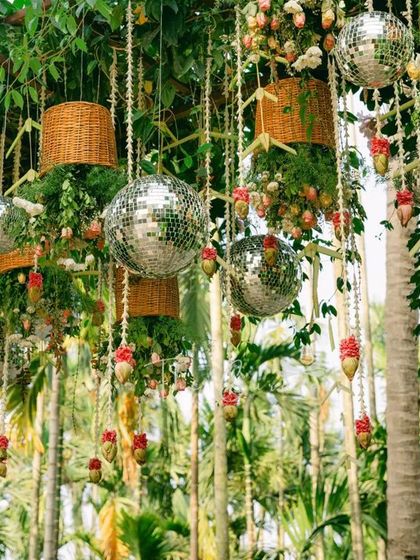 A close-up of the hanging decor, showing the mix of wicker baskets, floral arrangements, and shimmering disco balls that define our unique fusion style.