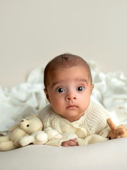 A sweet tummy-time shot of the baby girl. Her big, beautiful eyes are just captivating.