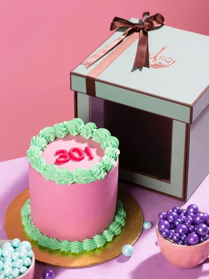 I believe even the smallest cakes can make a big statement. This custom mini pop cake, with its vibrant pink and green frosting, is perfect for personal celebrations and comes ready to gift in my signature box.