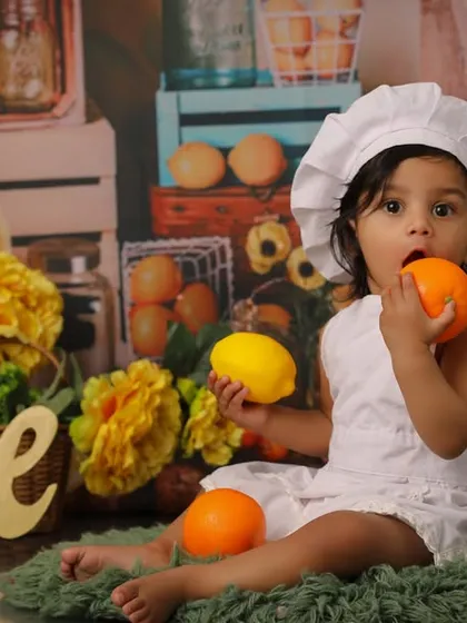 When life gives you lemons, you have a fun first birthday photoshoot. This little chef is enjoying a taste of citrus during her unique and colorful fruit-themed session.