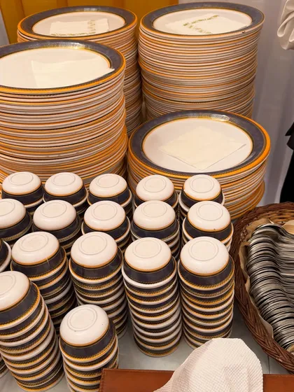 We provide high-quality crockery and cutlery for all our events. Here, you can see our stylish plates and bowls, neatly stacked and ready for guests.
