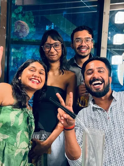 Friends enjoying drinks and laughs, soaking in the lively atmosphere of a Friday night.