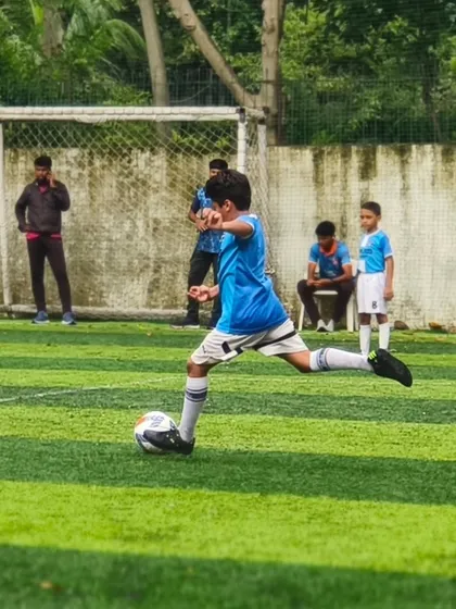 A player from our U11 squad unleashes a powerful shot during a competitive match.