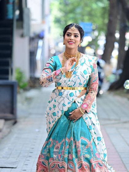 A beautiful candid of Preethi. The makeup is designed to look natural and glowing, perfect for a daytime family event.