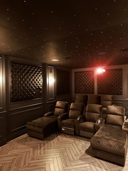 I blend classic European elegance with modern cinema technology. This project in Thoothukudi showcases deep, tufted wall paneling, herringbone wood flooring, and custom-designed recliners with chaise lounges for a truly luxurious and comfortable atmosphere.