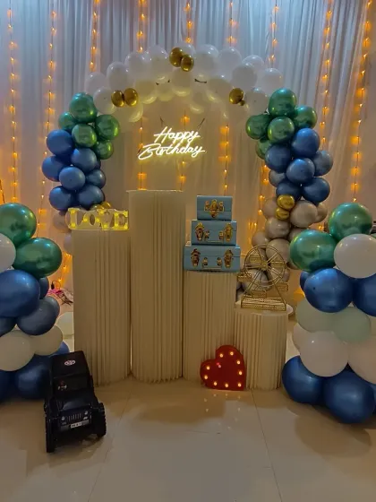 Another angle of the blue and green birthday setup, showing a small toy car prop. I can include small props like this to match your party's theme.