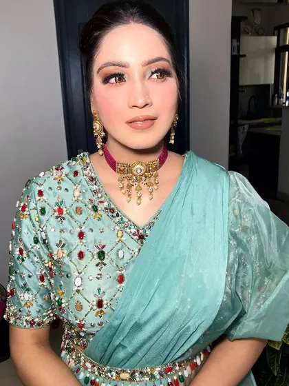 A close-up of the look, showing the colorful embroidery on her blouse and the unique choker.