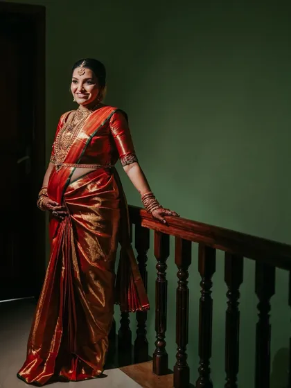 The deep, lustrous red of this silk saree is perfect for a celebration of life. The traditional gold border adds a touch of regal elegance.