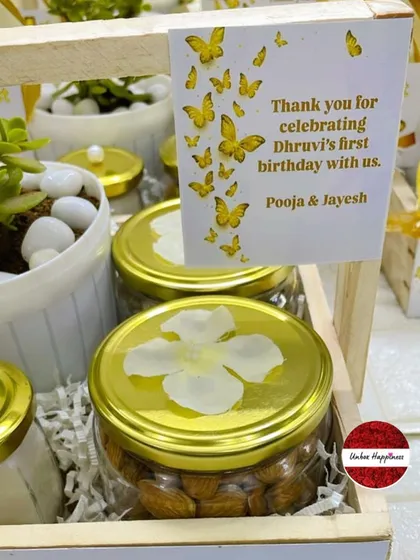 A close-up of the personalized thank you card and the custom-lidded jar of almonds in the butterfly-themed favor.