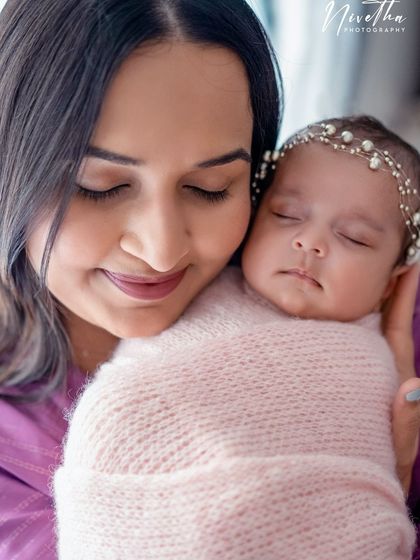 A mother's love. A close-up of a mom holding her swaddled newborn, a moment of pure peace and connection.
