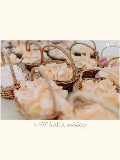 Baskets of delicate peach rose petals, ready for guests to shower the couple, a small but beautiful detail from the Dubai wedding.
