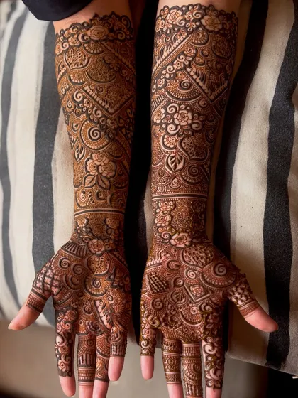 For this engagement bride, I designed a full-arm henna that combines traditional patterns with modern aesthetics. The fine linework and balanced composition ensure the design is both bold and elegant.